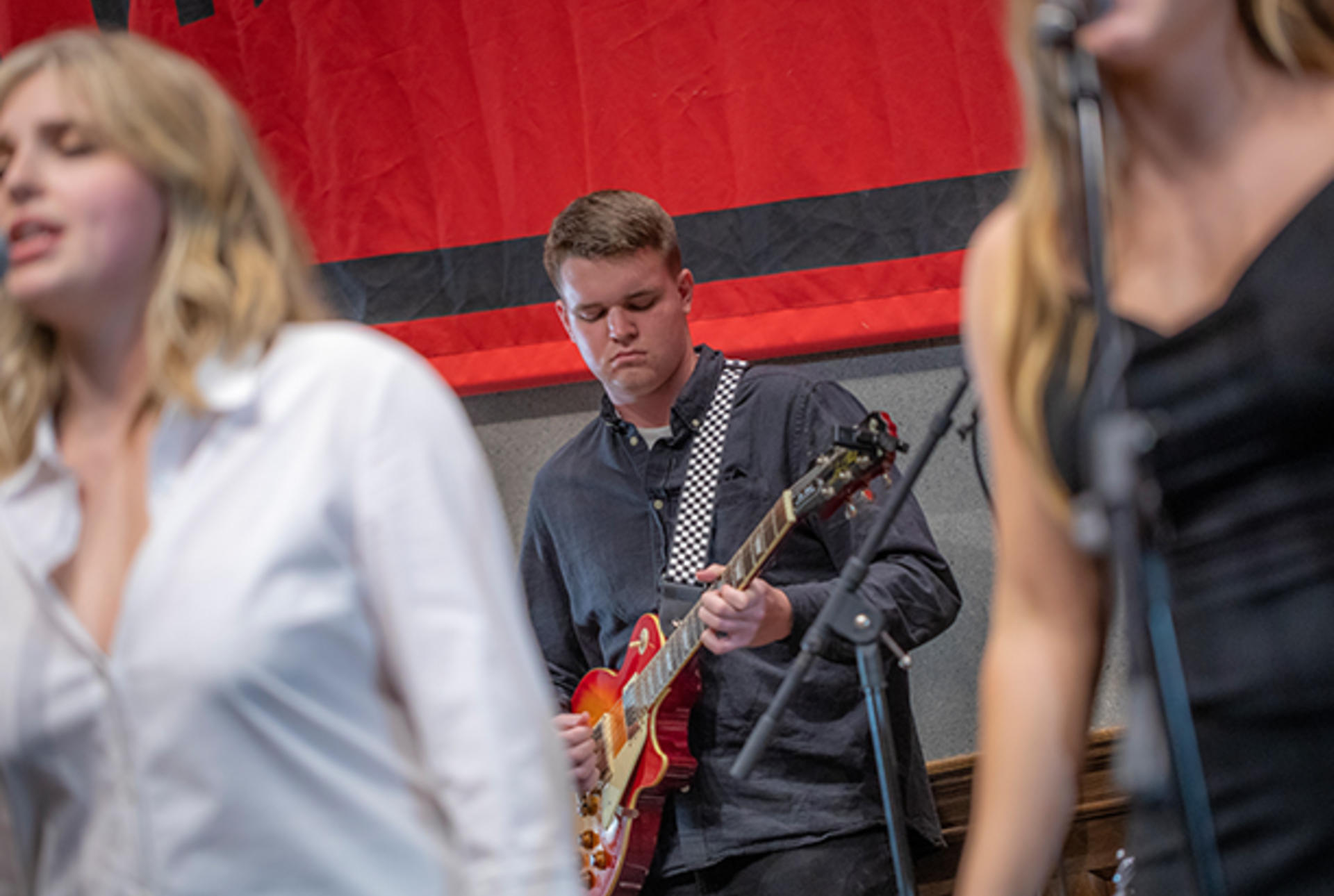 students singing and playing instruments on stage