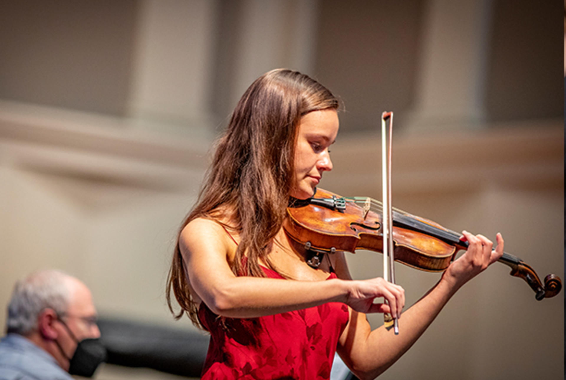 a young woman plays the violin