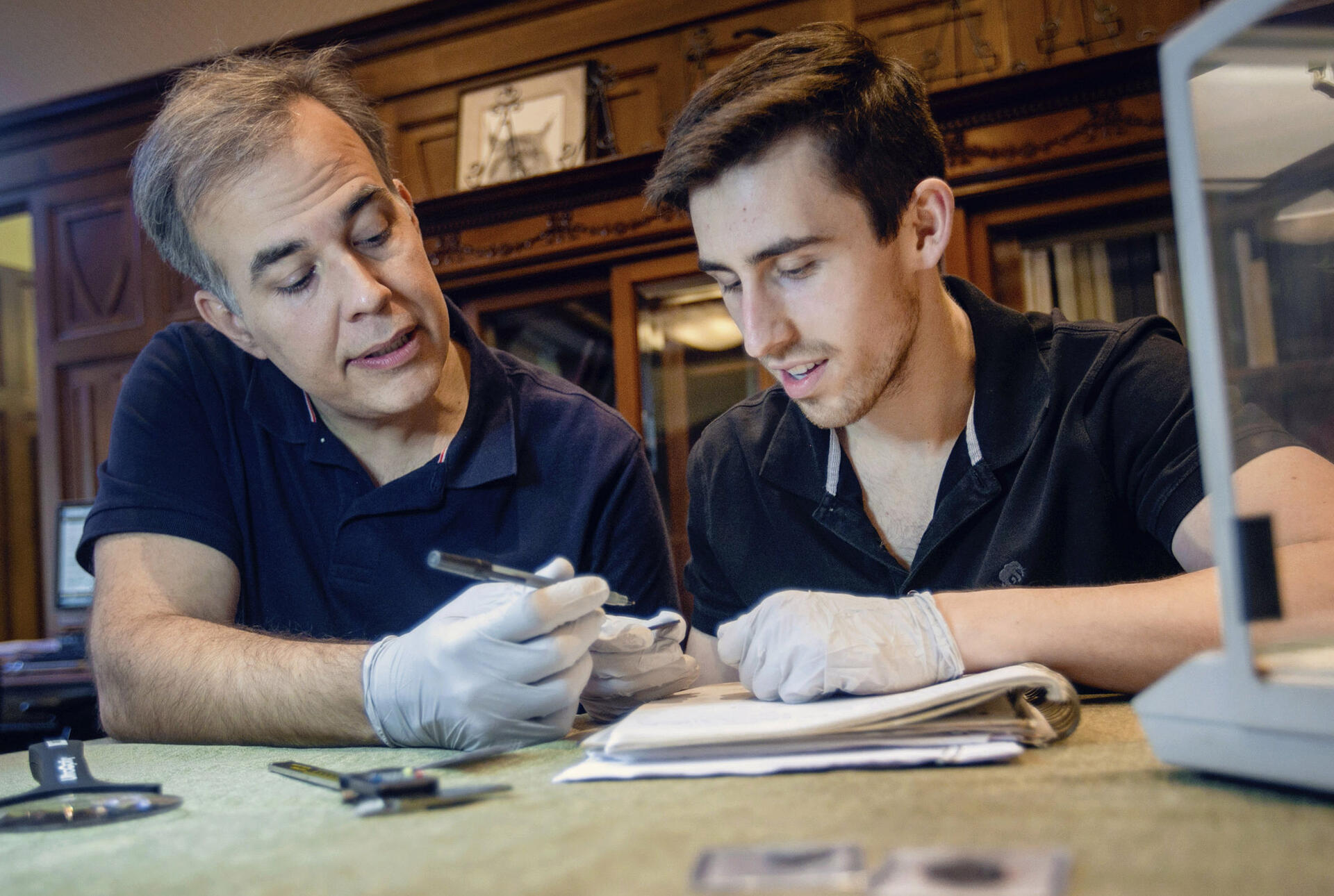 a professor and a student examining an artifact