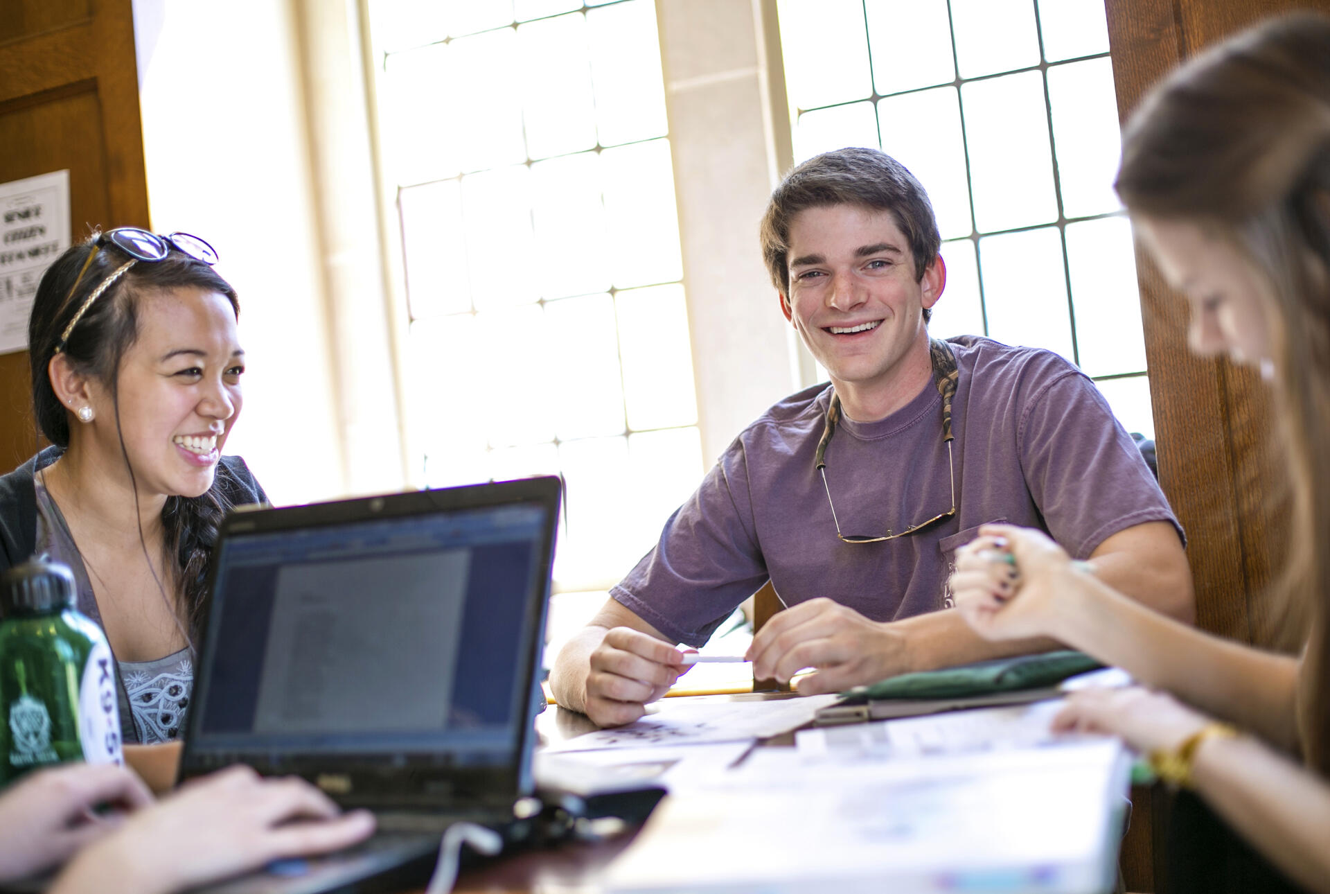 a group of students talking around a table