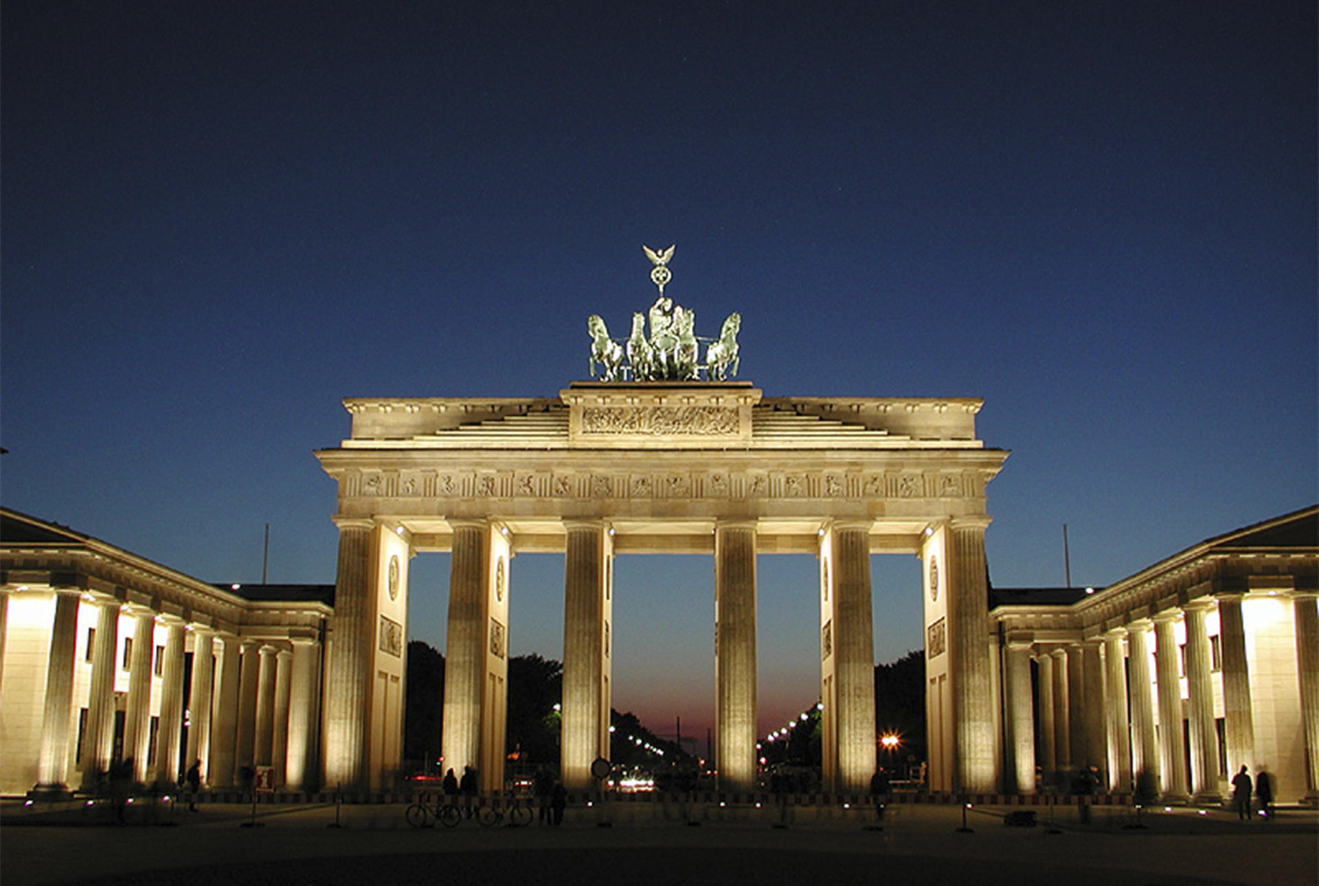 Tall arch with multiple columns lighted at night