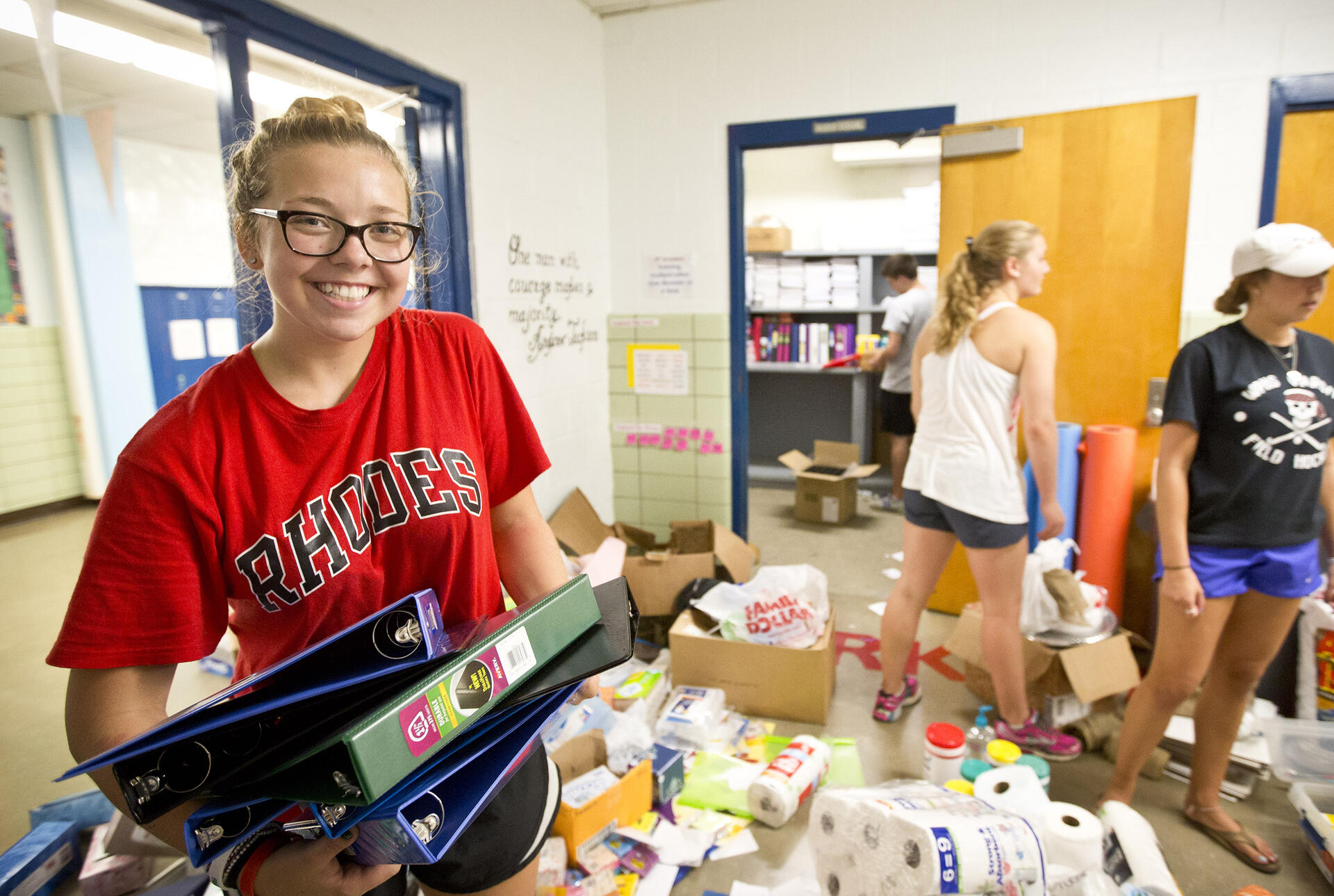 a young woman helps hand out supplies