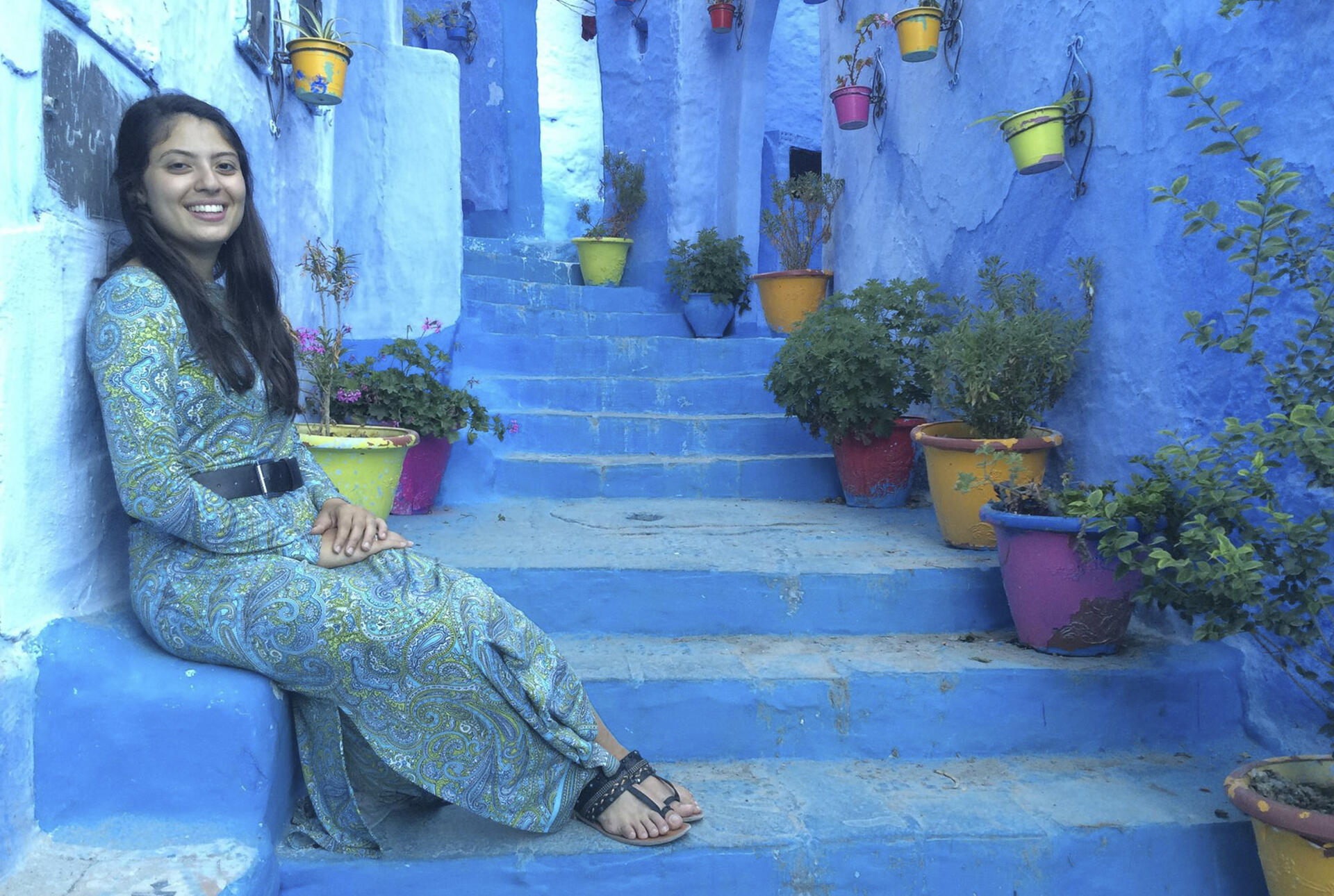 a student sitting on some steps in a foreign land
