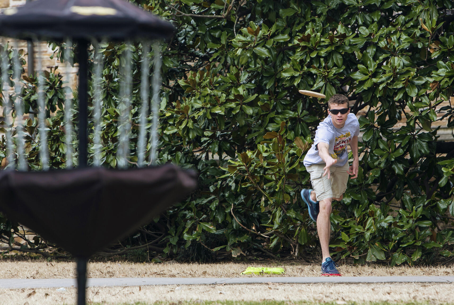 a student throws a frisbee