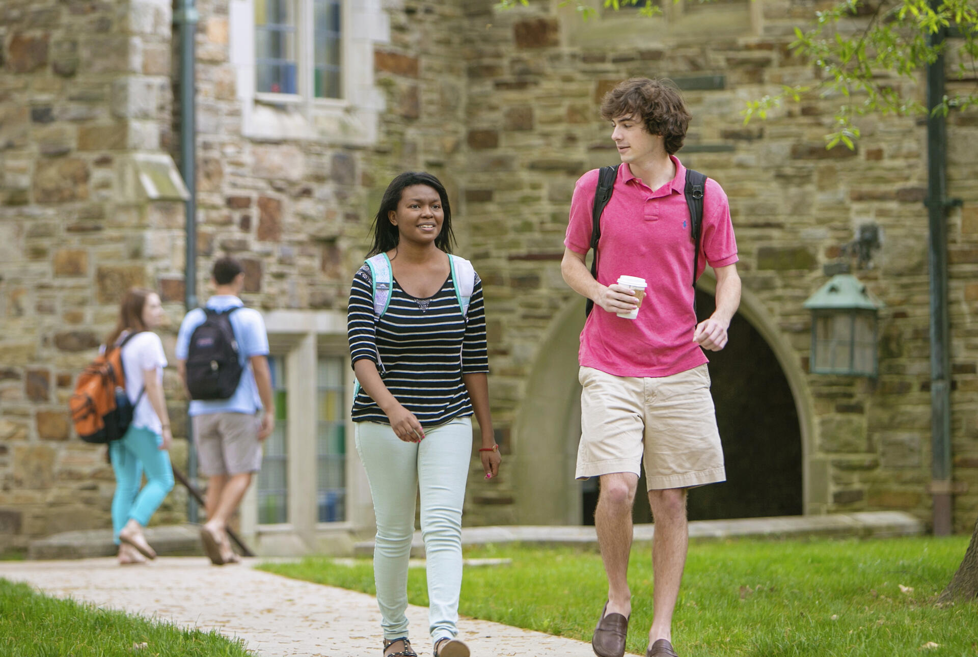Students walking and talking on a sidewalk