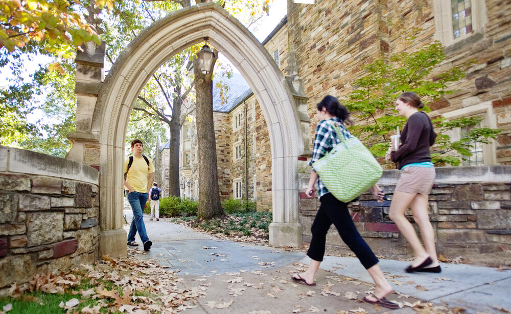 Students walking through arch