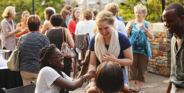 Students laughing with one another at a parents social.