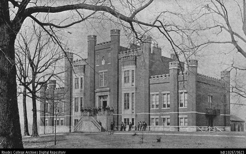 A black and white photo of a stately building in winter
