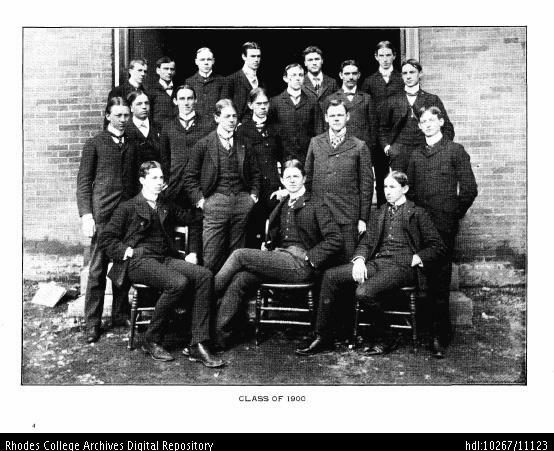 A black and white photo of a group of white men dressed in 19th century formal attire