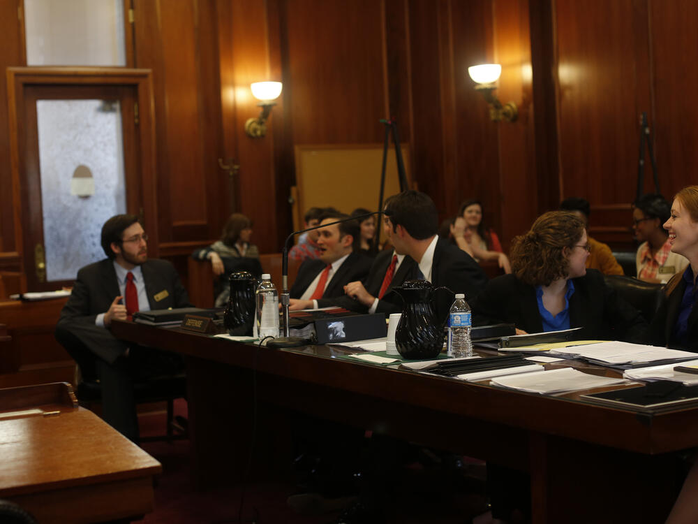 The inside of a dark-wood-paneled courtroom.