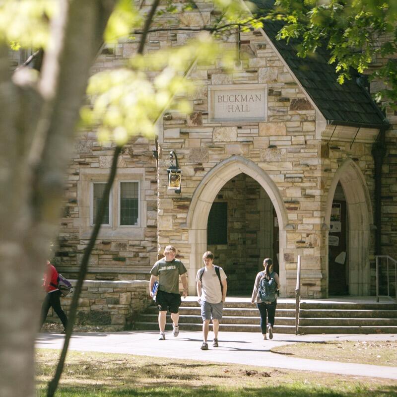 Buckman Hall at class change on a sunny spring day.