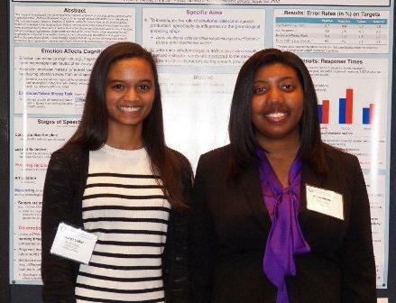 two female students with long dark hair and name tags