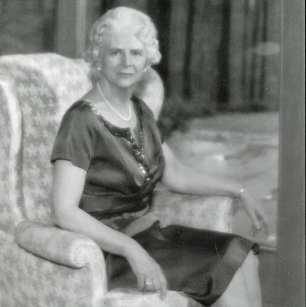 an older lady sitting in a wing chair