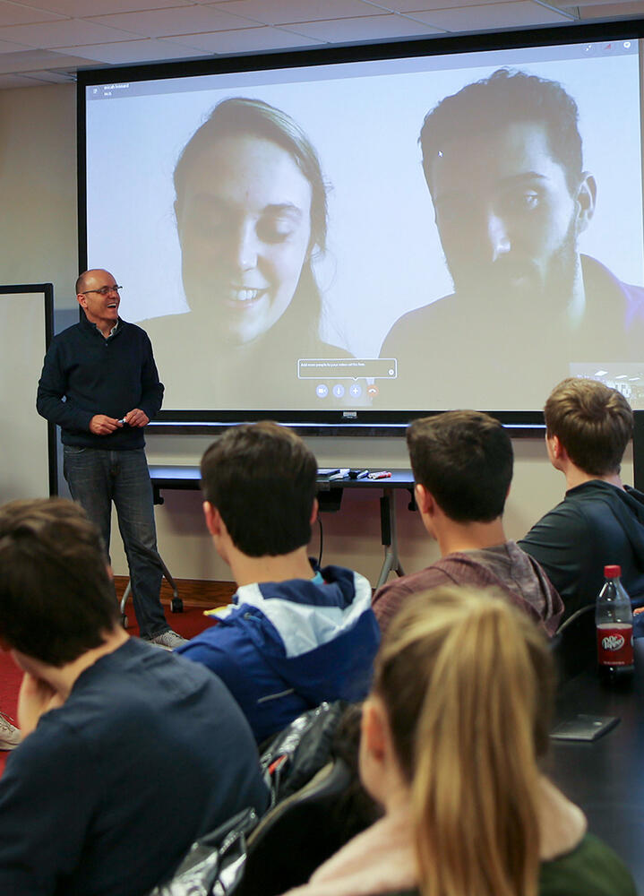 a professor in front of a screen