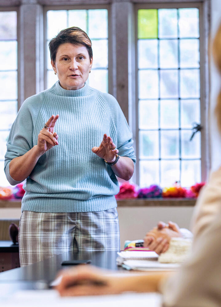 a female professor leads a class