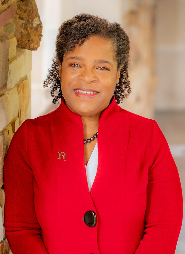 an African American woman in a red suit