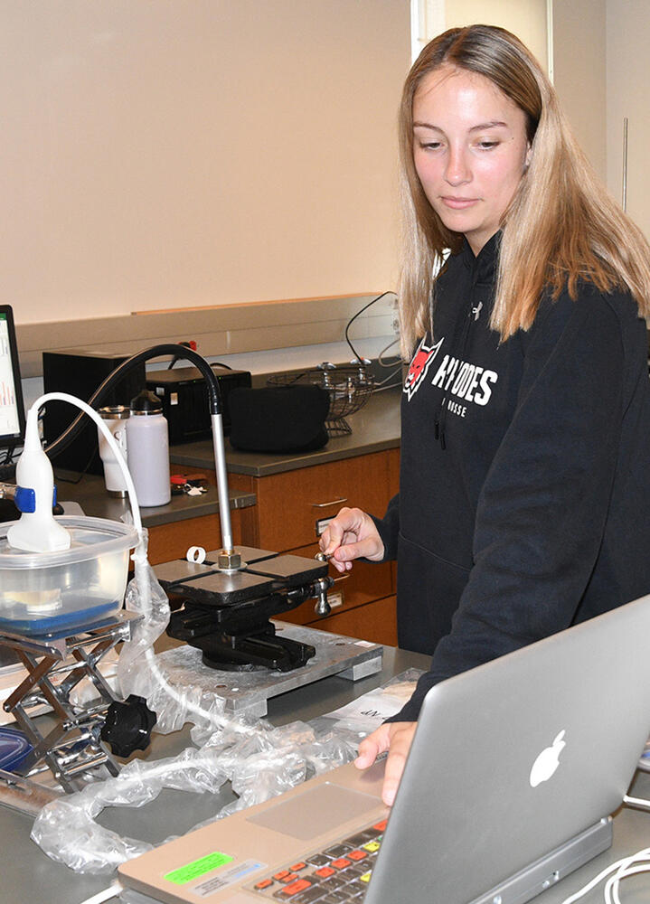 a student with a computer and lab instruments