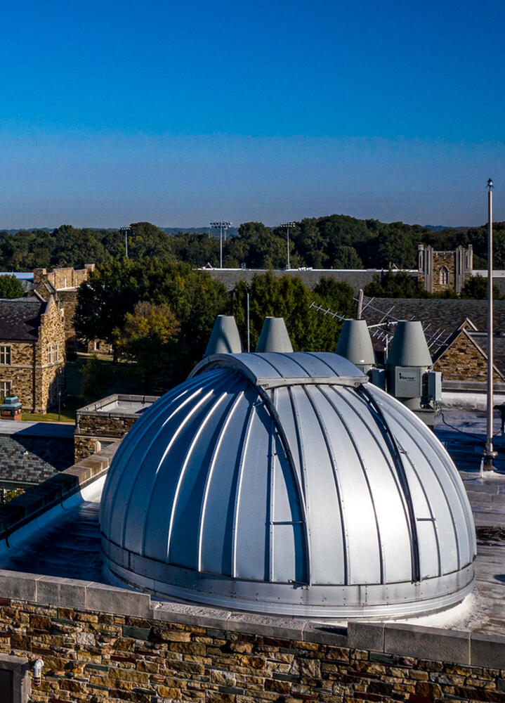 a large telescope housing on a rooftop