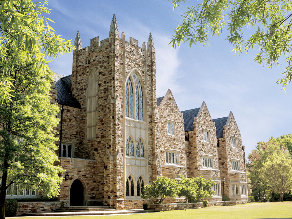 a stone Gothic building with a tower