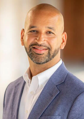 an African American man in a blue suit