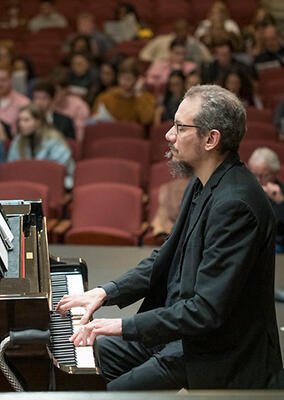 a man plays piano on stage