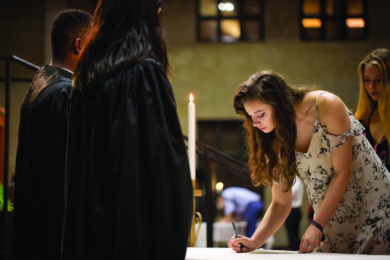 a young woman signs a pledge