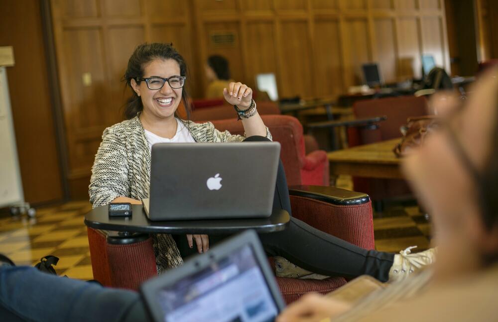 A student at a desk with a laptop