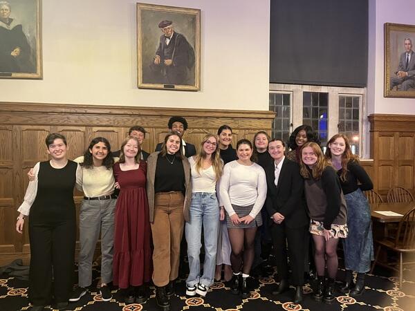 students gather for a group shot at a dinner