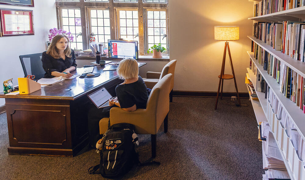 a female professor holds office hours with a student