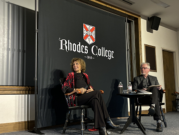 a man and a woman talk on a stage