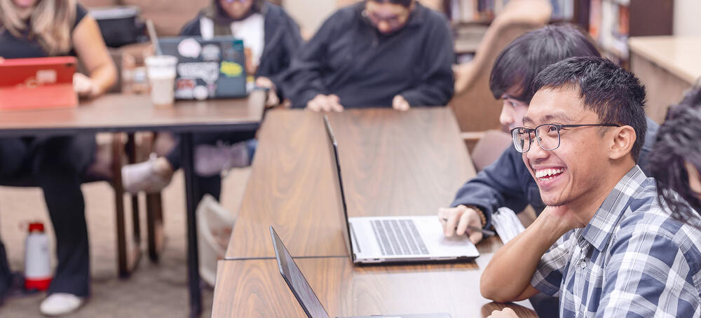 a young man from Indonesia enjoys a class with other students