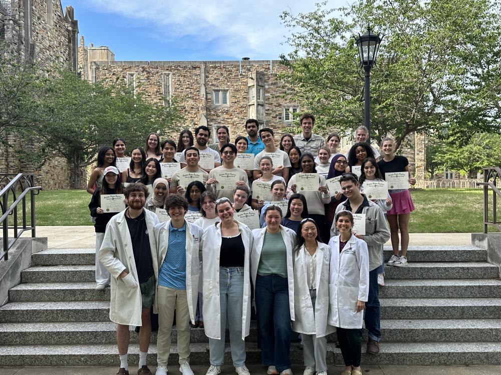 a group of students pose on steps