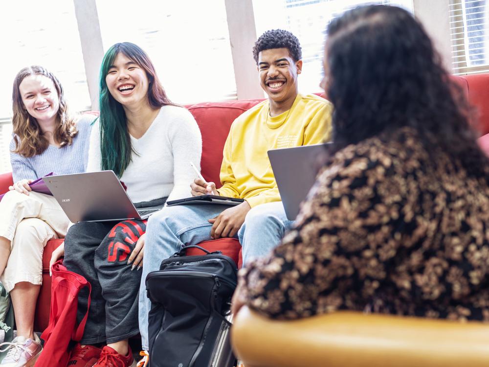a professor talks with students