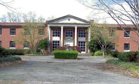 a brick building with white columns