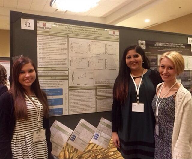 Students in front of a poster presenting research