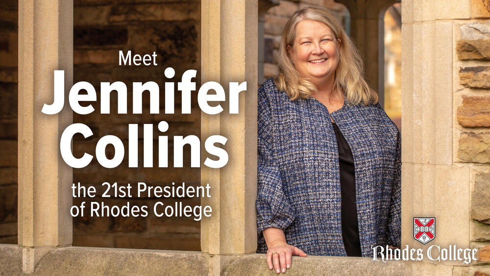 Jennifer Collins smiles, standing between ornate columns