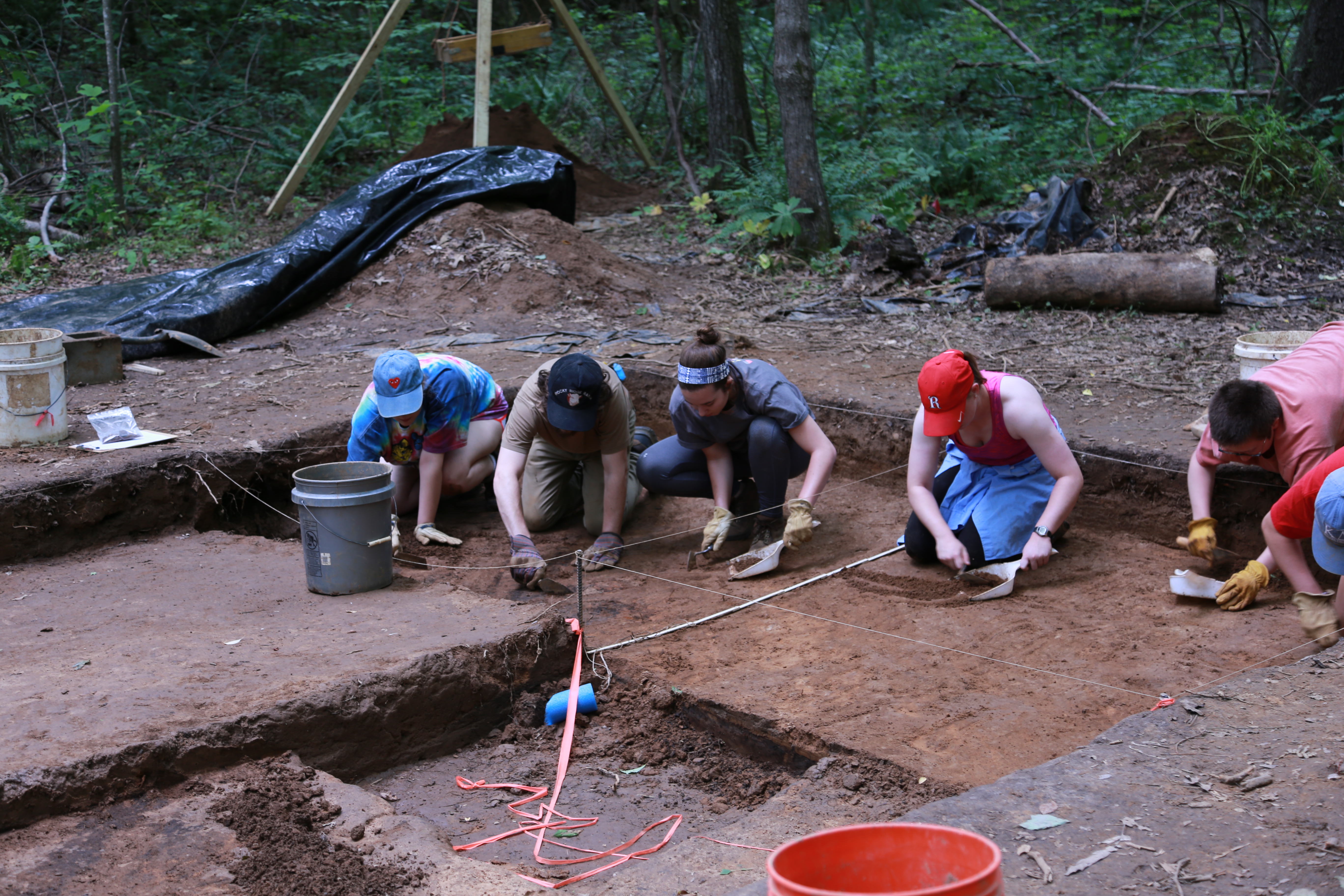 students digging at an archeological site