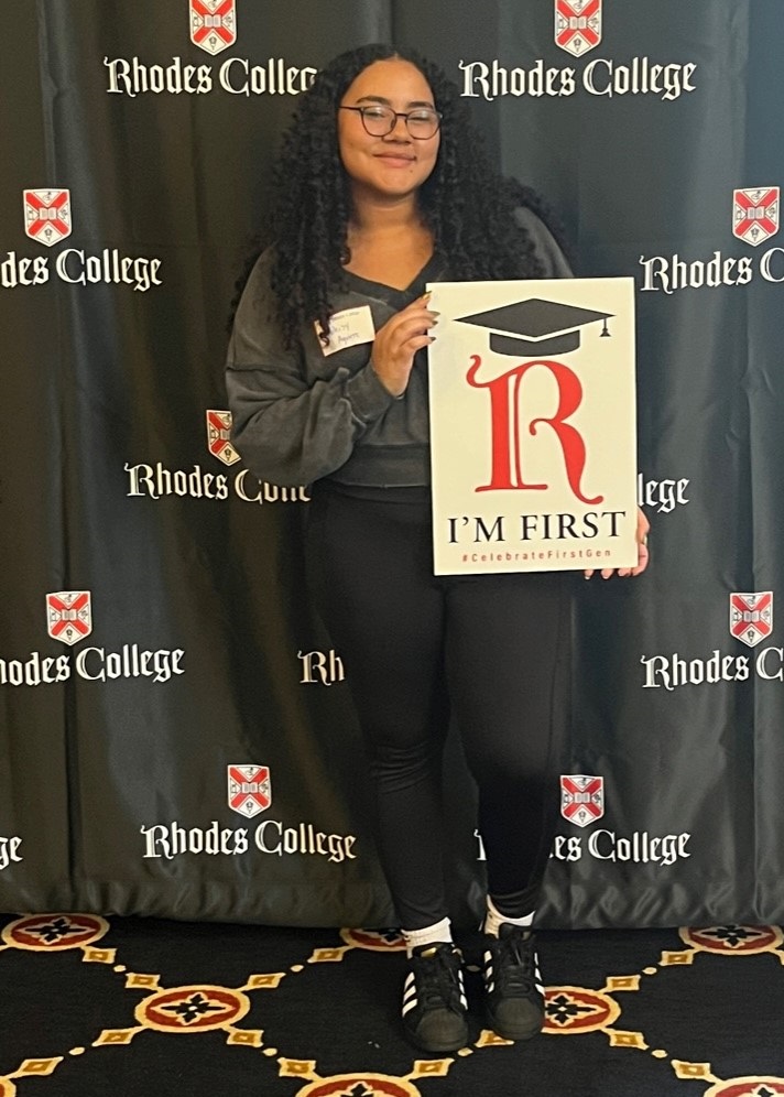 image of a student holding an I'm First sign