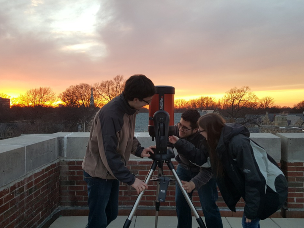 Students set up telescope for Department of Physics Open House